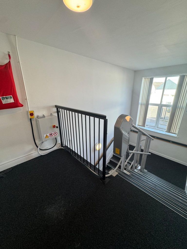 Top landing of the incline platform lift with control panel and isolator